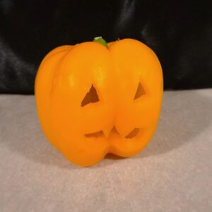 Bell pepper pet-safe Halloween treat carved like a pumpkin